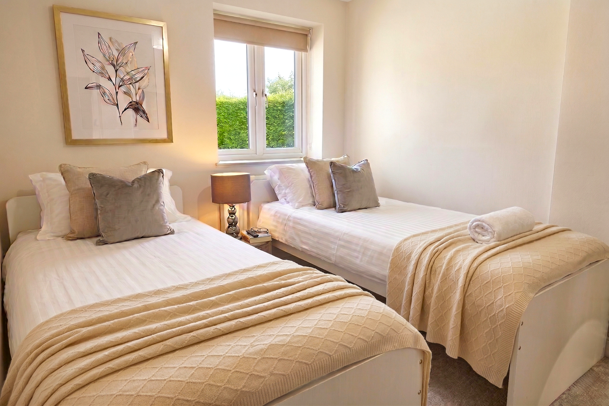 Twin room interior with cream throws